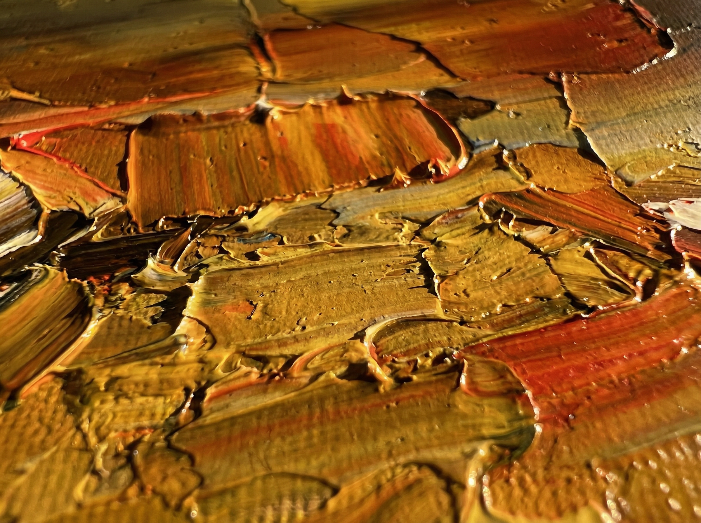 Extreme close-up of thick impasto brushstrokes on canvas, showing ridges and valleys of paint applied by palette knife with warm side-lighting revealing the texture